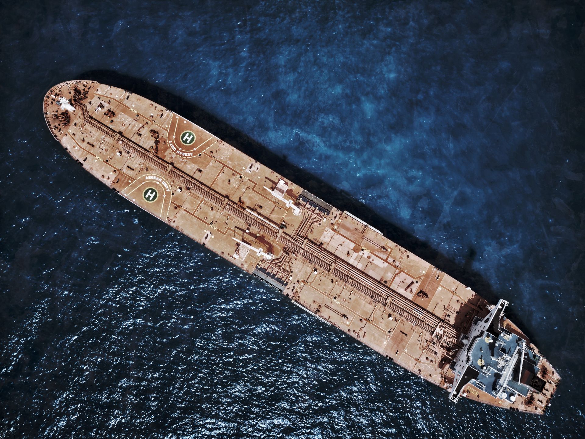 Aerial view of open water and a petroleum tanker